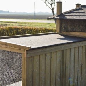 Het platte dakleer dak van de ren van kippenhok hooiberg Rosa loopt schuin af voor de afwatering