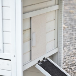 Het deurtje van het nachthok kan naar links en naar rechts geschoven worden